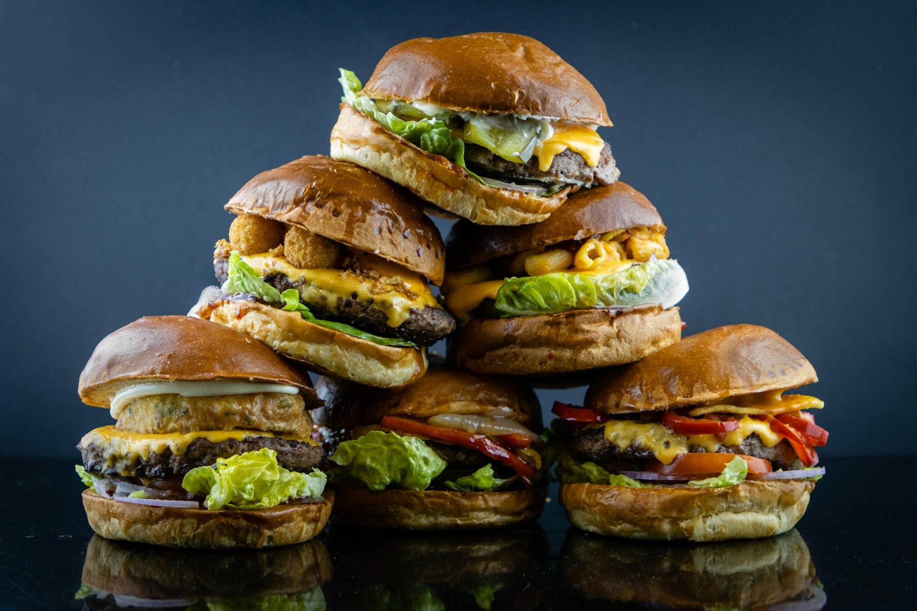Stacked smashburgers with cheese, lettuce, and brioche buns