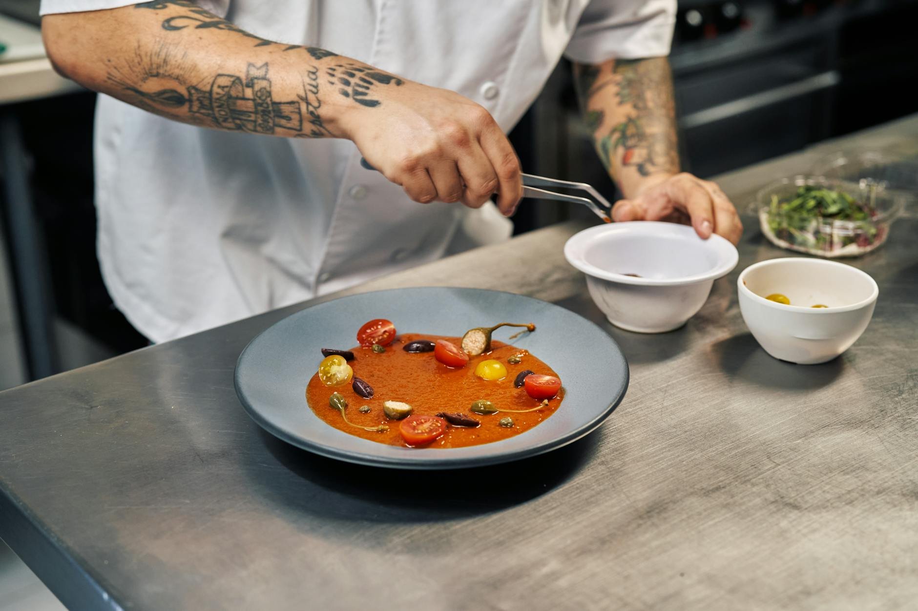 Chef's hands plating food with care